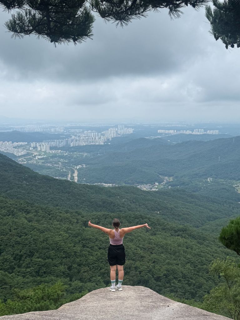 Hiker arms out at Bukhansan summit
