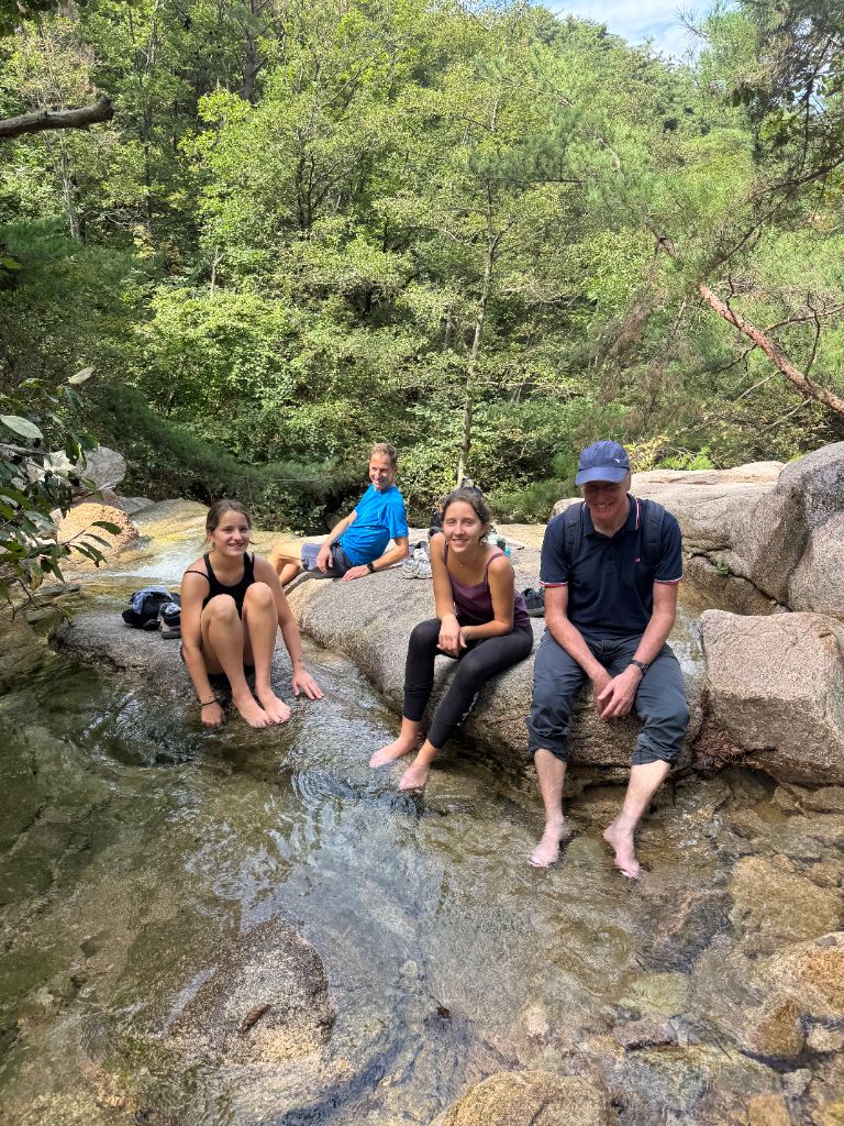 Guests soaking feet in stream