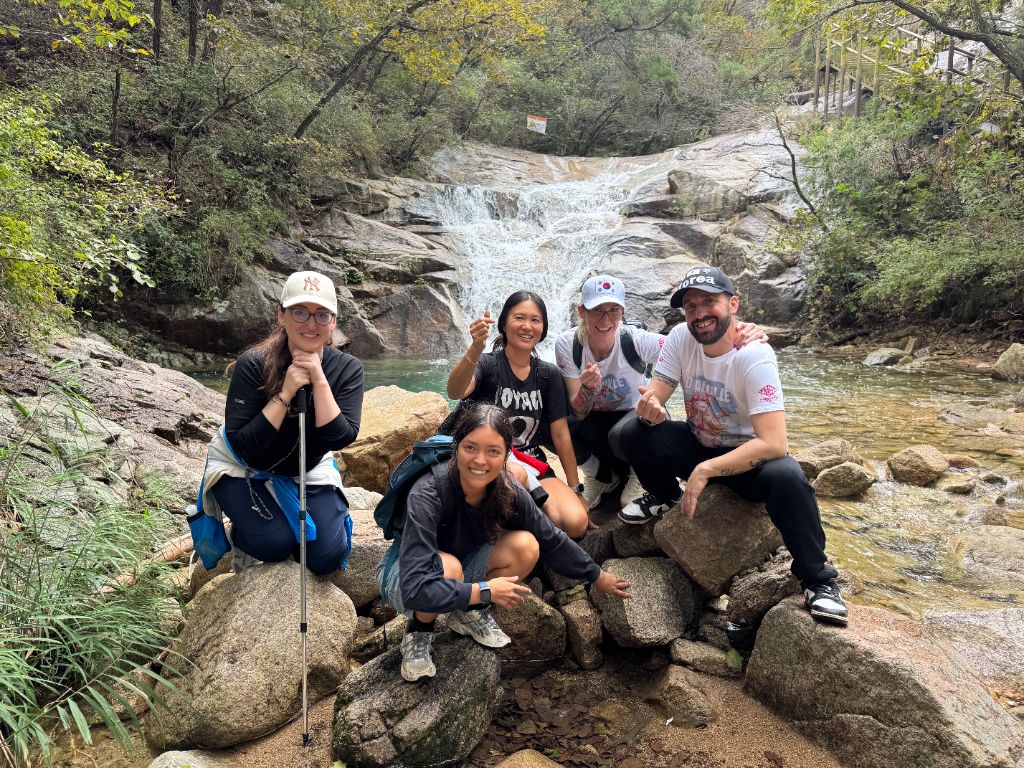 Group photo at stream waterfall