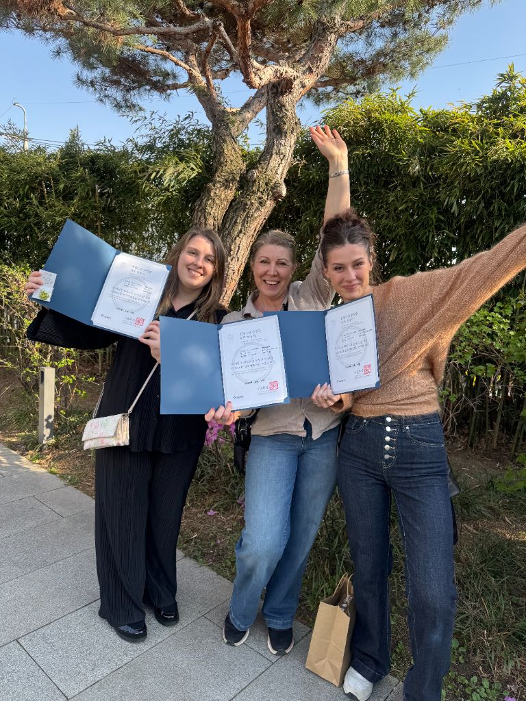 Group celebrating with completion certificates