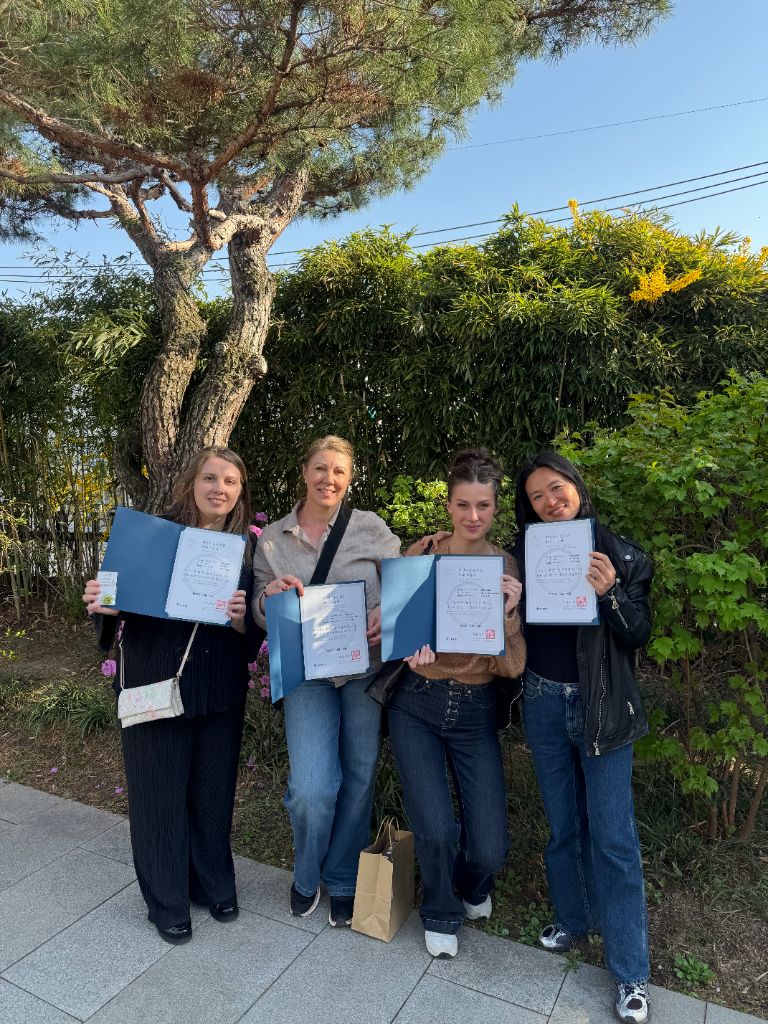 Group proudly showing Seoul City Wall certificates