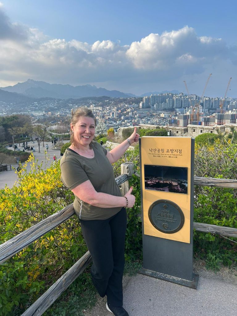 Guest at Naksan Park viewpoint sign