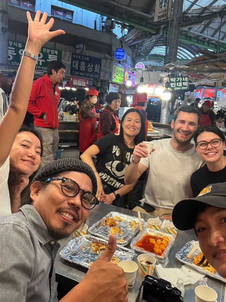 Group eating at Gwangjang Market counter