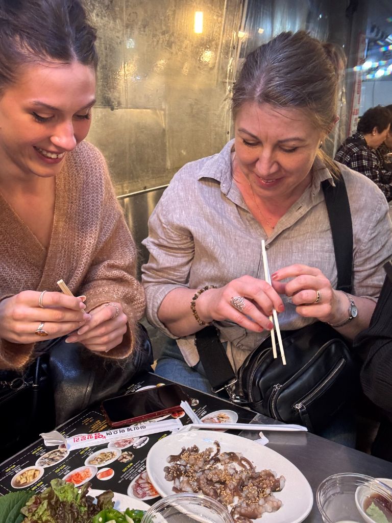 Guests enjoying raw seafood with chopsticks