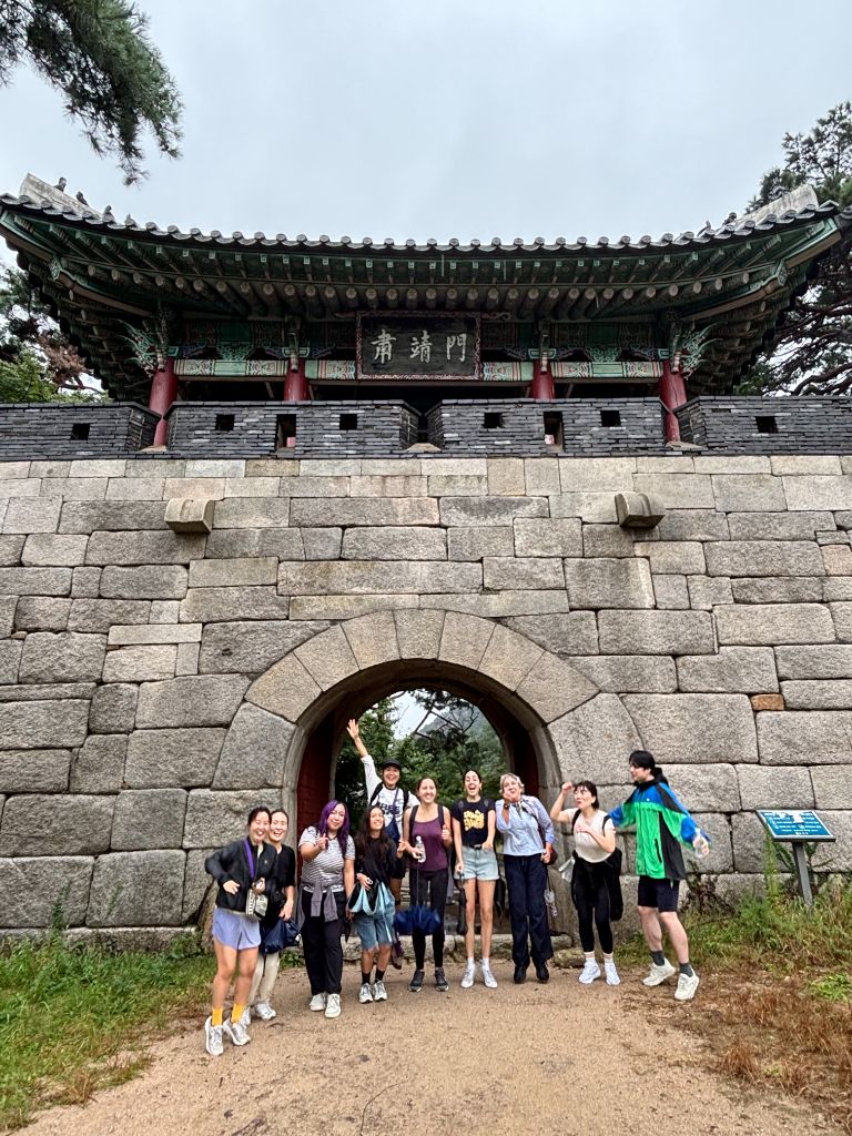 Group photo at historic stone gate