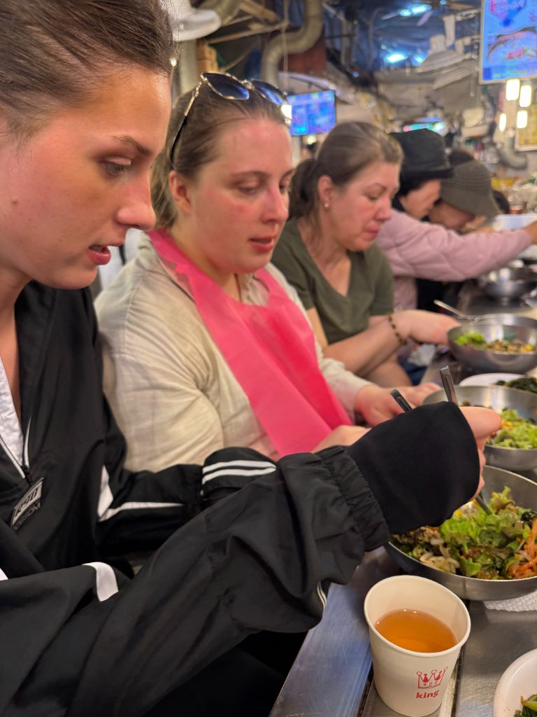 Guests enjoying Korean food at market counter