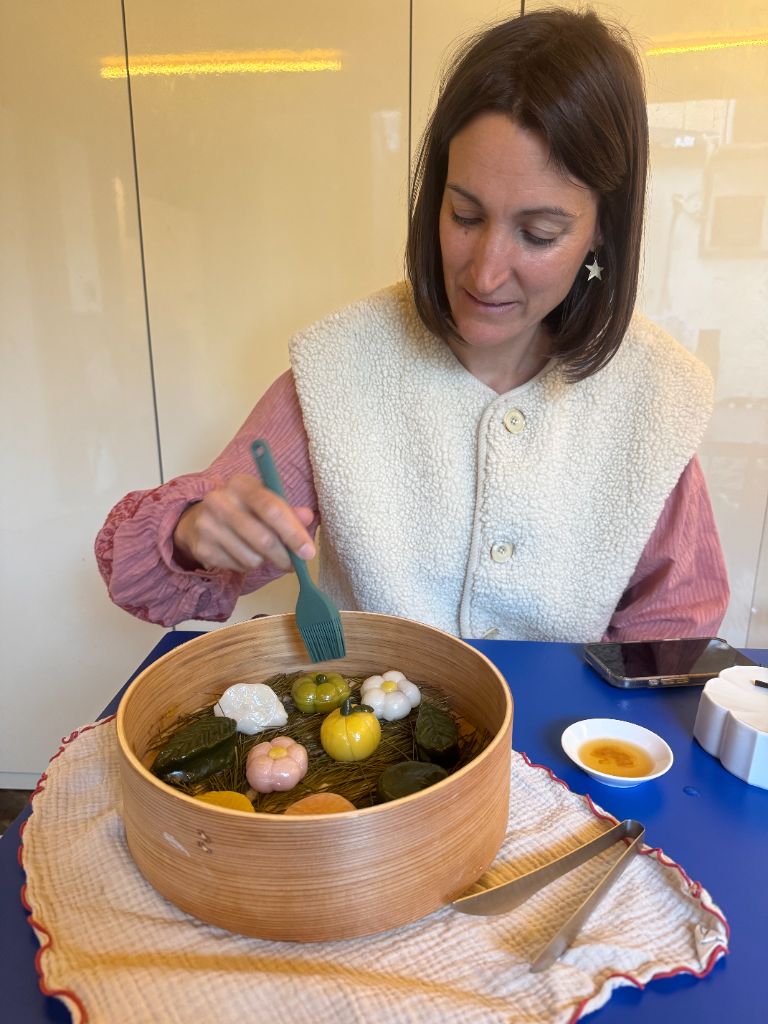 Woman organizing tteok in wooden steamer